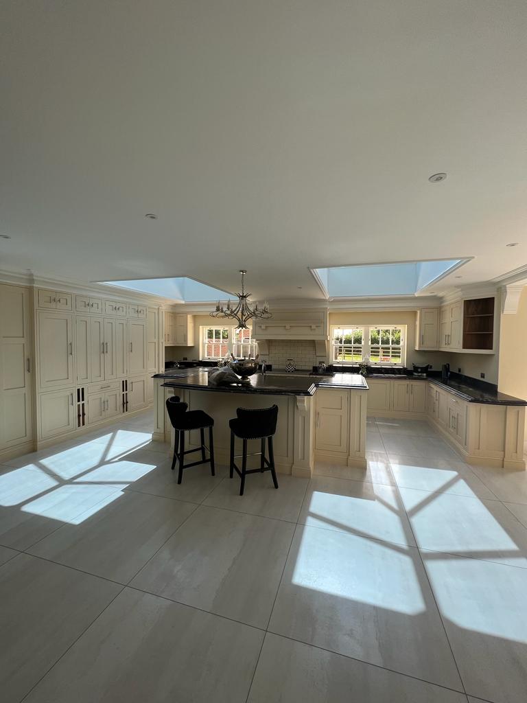 Classic white kitchen design with bespoke mantle and larder cupboards – Kitchens Essex project by Regent St James.