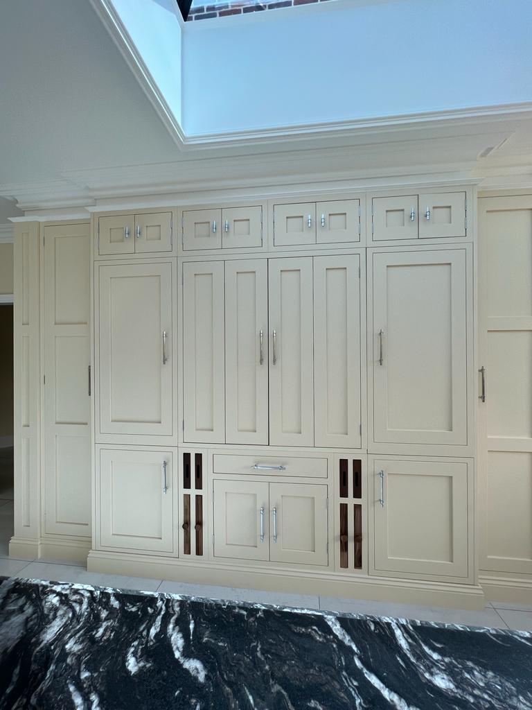 Beautiful magnolia-finished kitchen with traditional hand-painted cabinetry – bespoke Kitchens Essex design.