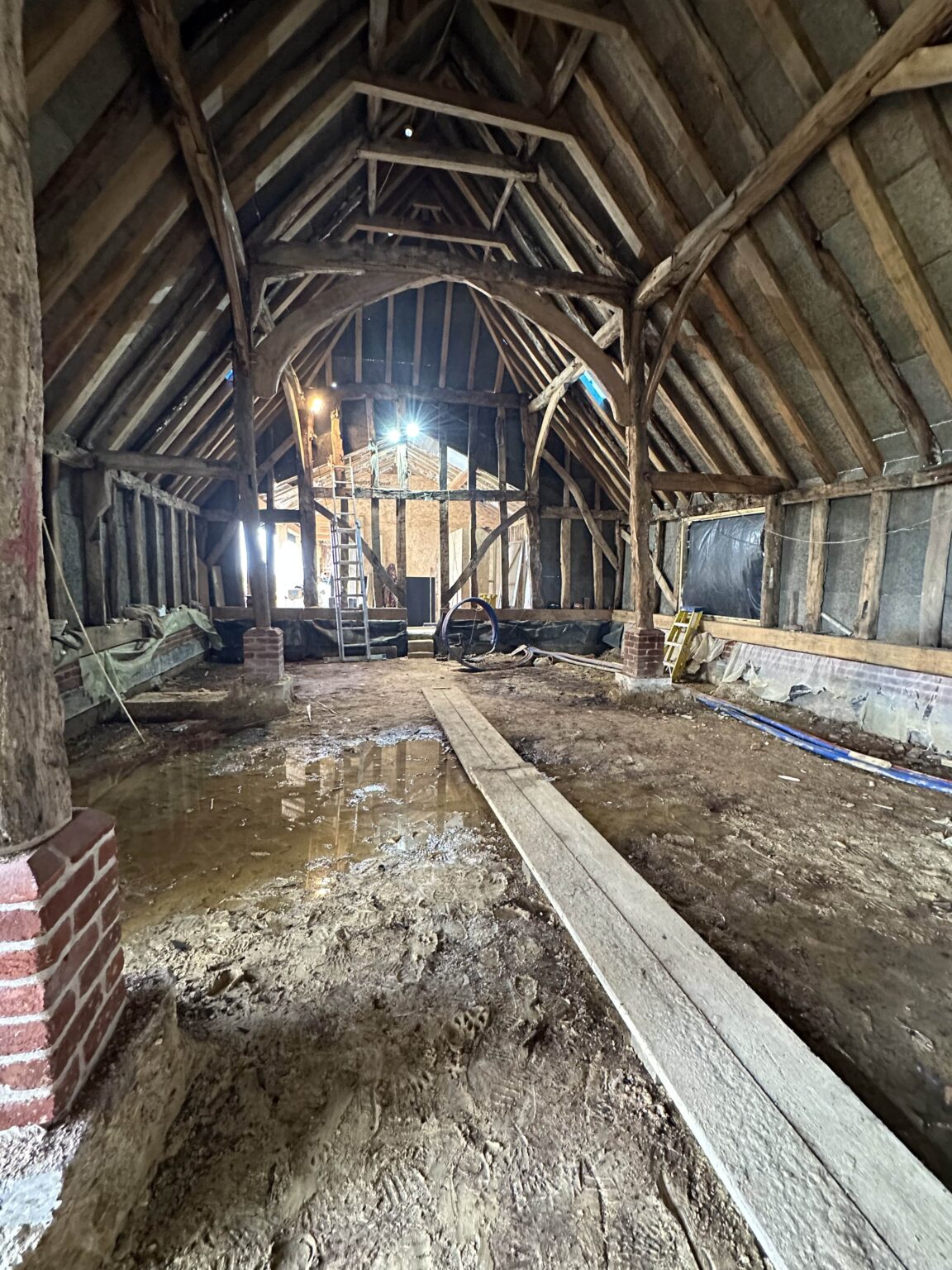 Handmade kitchen in Thaxted with twin Liebherr fridges, acoustic panelling, and ambient under-unit lighting.