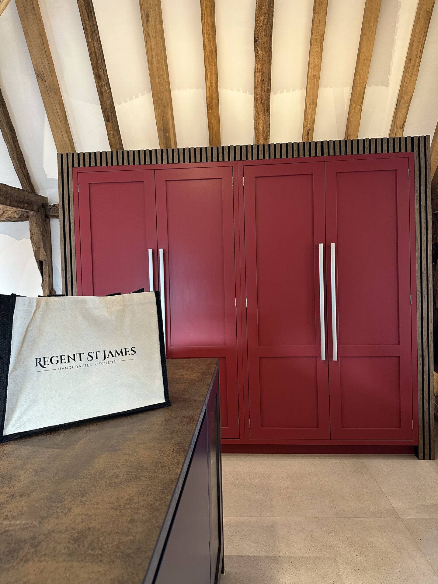 Bespoke kitchen in Thaxted featuring Paen Black and Rectory Red cabinetry within a barn conversion home.