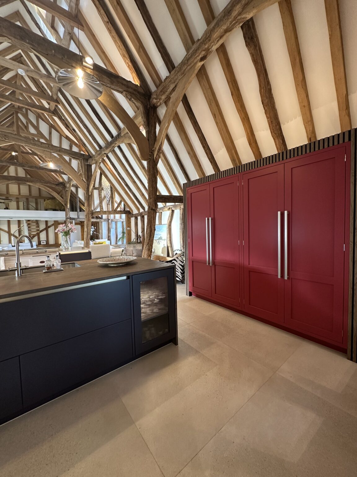 Luxury bespoke kitchen design in Thaxted with floating larder units and dark wood-stained interiors.