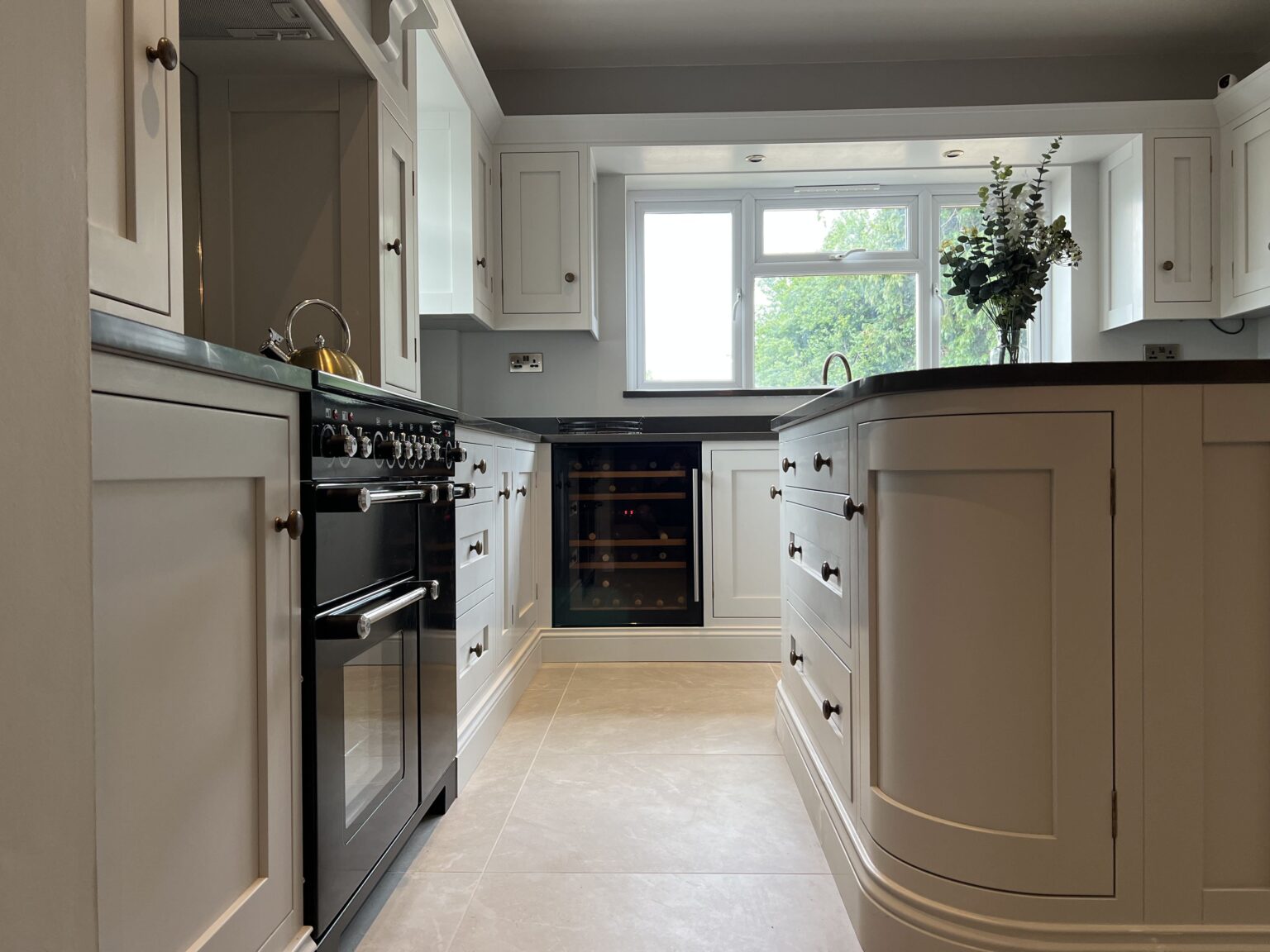 Glass display units with internal lighting in an elegant bespoke kitchen in Sible Hedingham