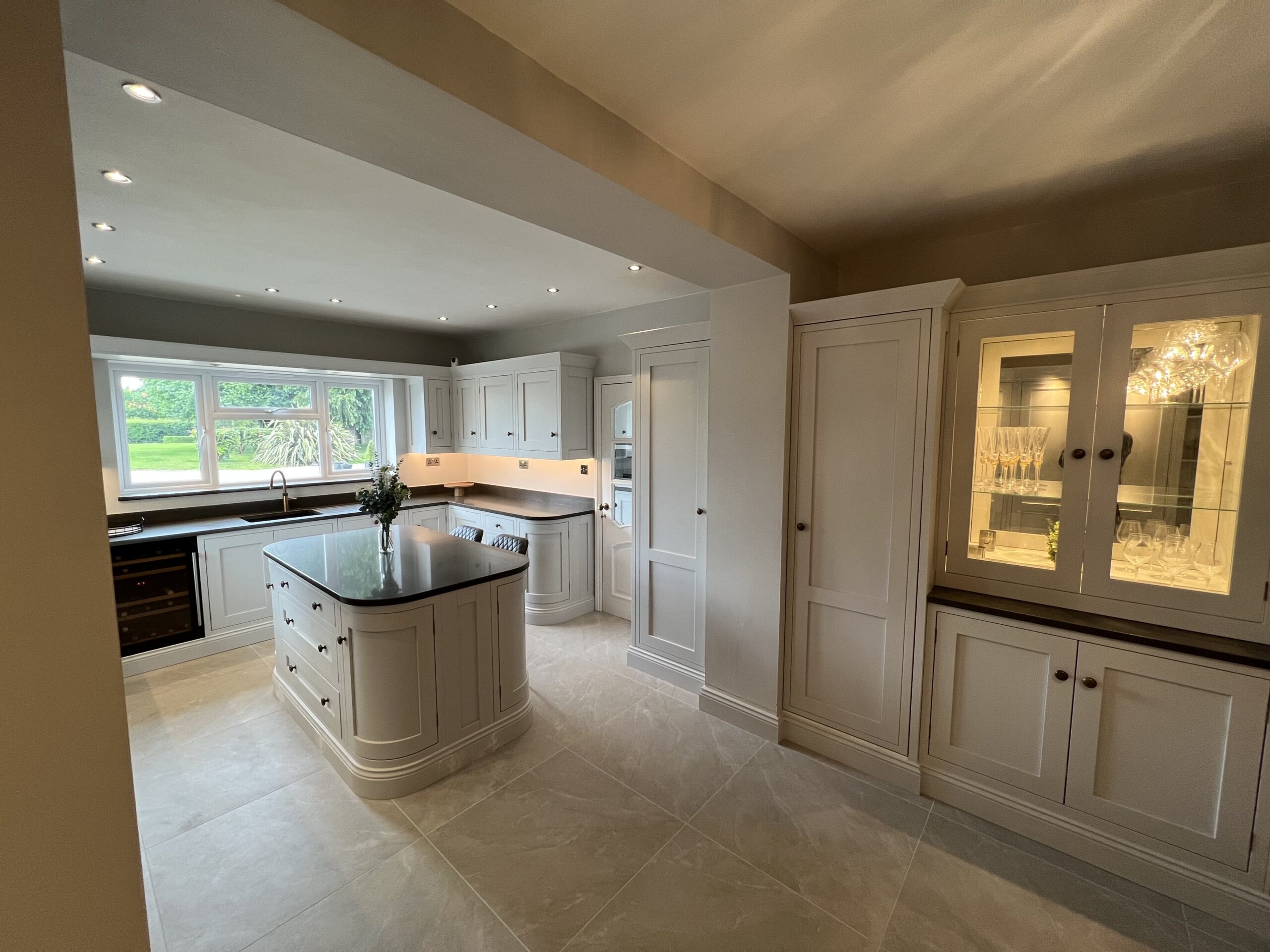 Bespoke kitchen in Sible Hedingham featuring curved island and light-filled open-plan layout