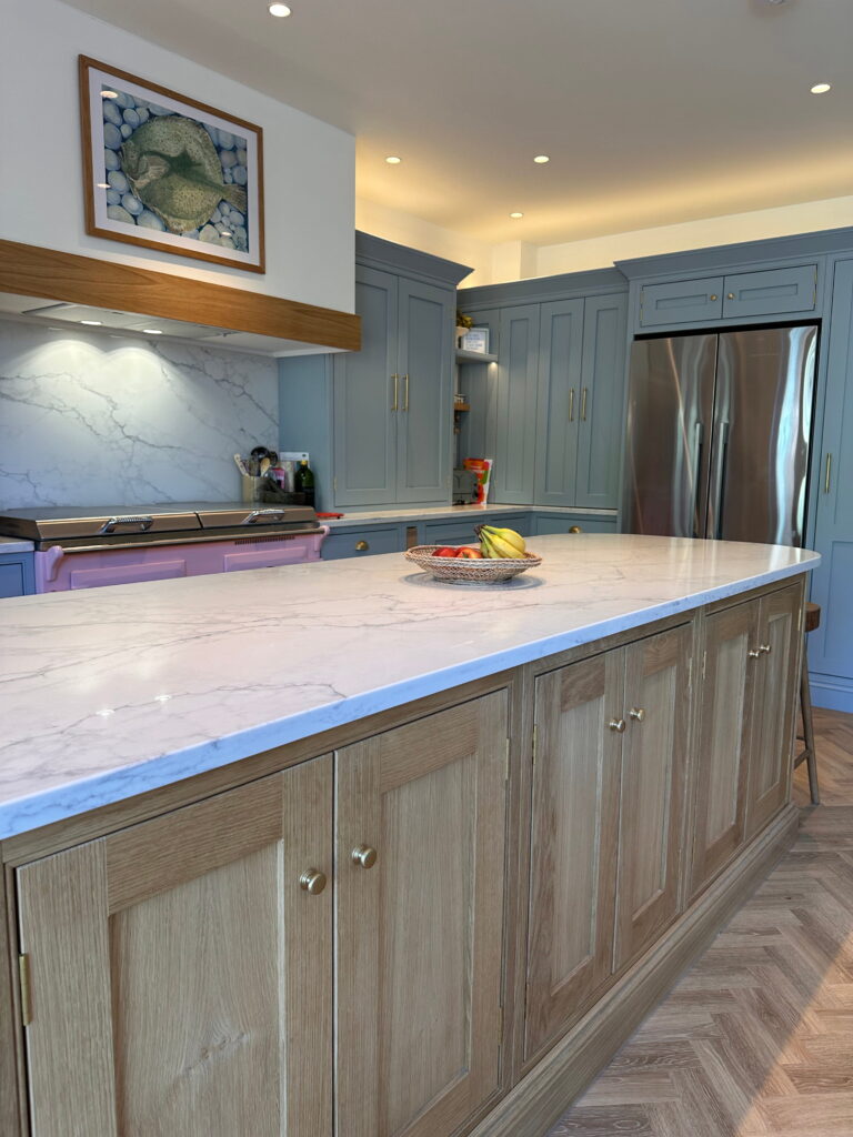 Bespoke Kitchen in Saffron Walden with oak island, marble worktop, and blue shaker cabinets
