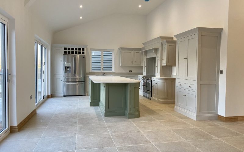 Modern bespoke kitchen with central island designed by a professional kitchen designer.