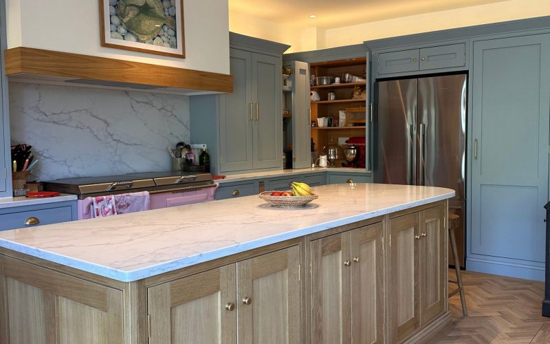 Bespoke Kitchen in Saffron Walden with oak island, shaker cabinets, and herringbone flooring.