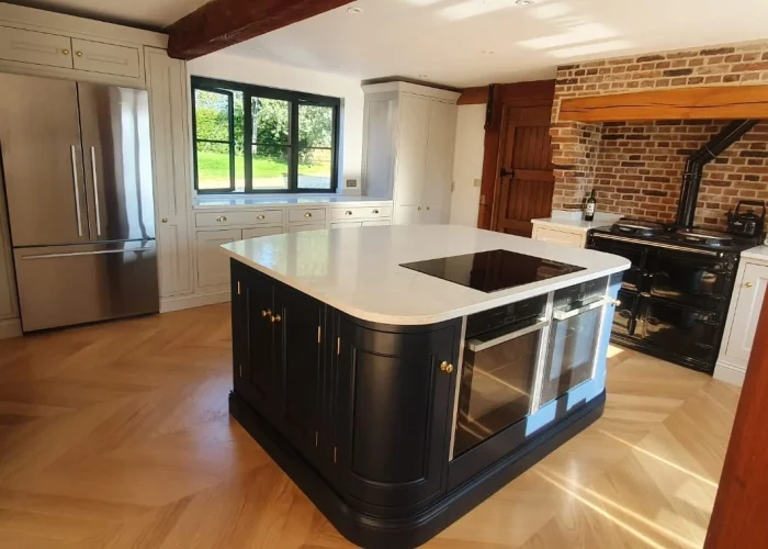 Kitchen island ideas showing a white topped kitchen island with black surround.