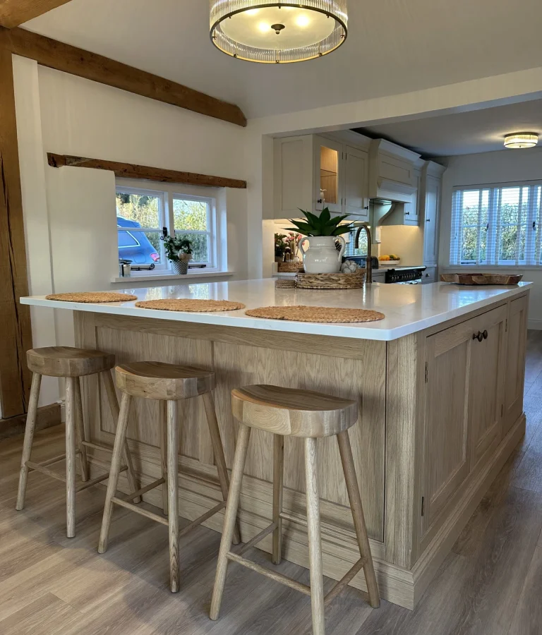 Kitchen island ideas: White marble topped kitchen island with light hanging overhead